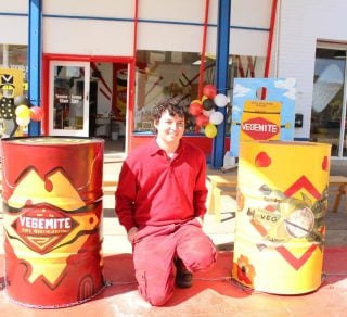 Artist Jay Van Nus with two of the Vegemite thru History drum art related image