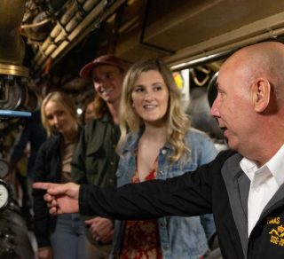 Submarine tour guide showing a tour group the submarine related image