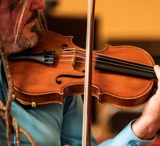 Man playing the violin related image