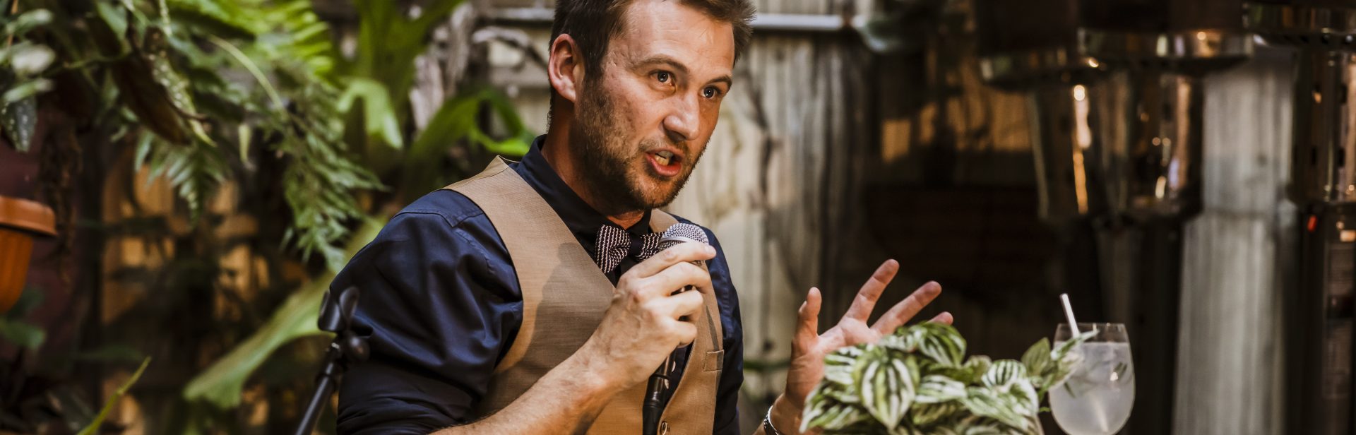 A presenter holding a microphone and  telling a story