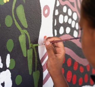 Young child painting a mural related image